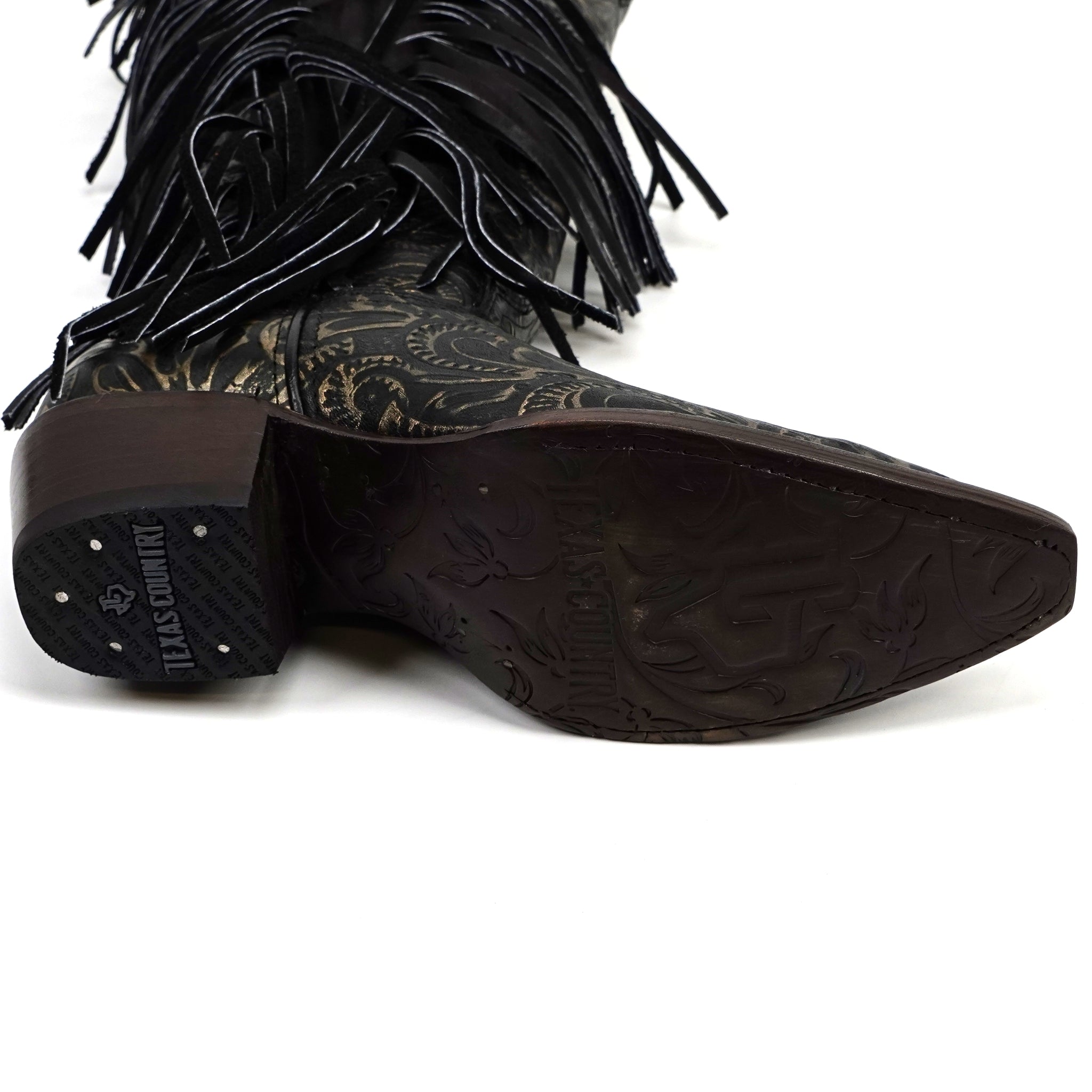 Black fringe cowboy boot with detailed sole on a white background