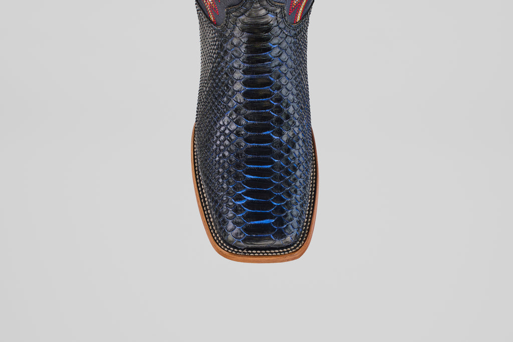 Top view of the McGraw – Navy – Square Toe boots, featuring men’s square-toe boots in dark blue snakeskin texture with a tan sole and detailed stitching from the Diamond Collection.